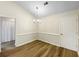 Bright dining area featuring wood floors, chair rail molding, and an elegant chandelier at 1792 Portwest Way, Hampton, GA 30228