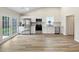 Modern kitchen with stainless steel appliances, white cabinets, and new floors at 1792 Portwest Way, Hampton, GA 30228