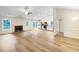 Inviting open-concept living space with hardwood floors, kitchen, and brick fireplace, great for entertaining at 1792 Portwest Way, Hampton, GA 30228
