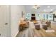 Bright, staged living room features a fireplace, neutral colors, and new floors at 1792 Portwest Way, Hampton, GA 30228