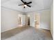 Serene primary bedroom with tray ceiling, plush carpet, and en-suite bathroom, designed for comfort and privacy at 1792 Portwest Way, Hampton, GA 30228
