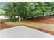 Well-maintained backyard with patio, lush lawn, and mature trees for privacy at 1980 Heatherton Rd, Dacula, GA 30019