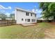 Expansive backyard featuring a white home, patio, and fenced border at 1980 Heatherton Rd, Dacula, GA 30019