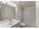 Bright bathroom with a shower-tub combo, tiled flooring, and a large vanity sink at 1980 Heatherton Rd, Dacula, GA 30019