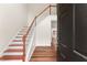 Inviting foyer with hardwood floors, a staircase, and an open view into the next room at 1980 Heatherton Rd, Dacula, GA 30019