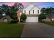 Charming two-story home featuring a brick and white exterior, landscaped yard, and an extended driveway at 1980 Heatherton Rd, Dacula, GA 30019