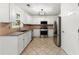 Well-lit kitchen features stainless steel appliances and plenty of cabinet space for storage at 1980 Heatherton Rd, Dacula, GA 30019