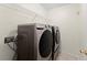 Convenient laundry room with front load washer and dryer and wire shelving at 1980 Heatherton Rd, Dacula, GA 30019