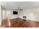 Bright living room features hardwood floors, fireplace, and a ceiling fan, creating a cozy atmosphere at 1980 Heatherton Rd, Dacula, GA 30019