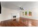 Bright living room features hardwood floors, fireplace, and large windows for natural light at 1980 Heatherton Rd, Dacula, GA 30019