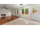 Inviting open concept living area featuring hardwood floors, a fireplace, and multiple windows at 1980 Heatherton Rd, Dacula, GA 30019