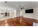 Open-concept living space featuring hardwood floors, a fireplace, and a seamless transition to the kitchen at 1980 Heatherton Rd, Dacula, GA 30019