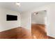 Bright living room featuring hardwood floors and an open doorway at 1980 Heatherton Rd, Dacula, GA 30019