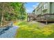 Wide shot of the backyard, featuring fire pit, deck, and green lawn at 11260 Havenwood Dr, Johns Creek, GA 30097