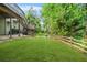 View of the backyard showing the deck, lawn, and perimeter fencing at 11260 Havenwood Dr, Johns Creek, GA 30097