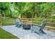 Backyard featuring fire pit, seating, playground, and perimeter fencing at 11260 Havenwood Dr, Johns Creek, GA 30097