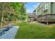 Wide shot of the backyard, featuring fire pit, deck, and green lawn at 11260 Havenwood Dr, Johns Creek, GA 30097