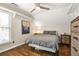 This bedroom features a ceiling fan, hardwood floors, a dresser and a comfortable queen bed at 11260 Havenwood Dr, Johns Creek, GA 30097