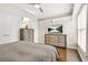 Cozy bedroom with a ceiling fan, hardwood floors, bright windows, and two stylish dressers at 11260 Havenwood Dr, Johns Creek, GA 30097