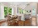 Dining area with a window view, seamlessly connected to the kitchen and living room at 11260 Havenwood Dr, Johns Creek, GA 30097