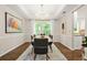 Bright dining room with modern chandelier, neutral walls, and access to other rooms at 11260 Havenwood Dr, Johns Creek, GA 30097