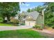 Charming two-story home with a well-manicured lawn, mature trees, and a two-car garage at 11260 Havenwood Dr, Johns Creek, GA 30097