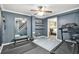 Home gym featuring a treadmill, weight bench, full length mirrors, and wooden stairs at 11260 Havenwood Dr, Johns Creek, GA 30097