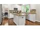 Bright kitchen with white cabinetry, a center island, stainless steel appliances, and wood floors at 11260 Havenwood Dr, Johns Creek, GA 30097