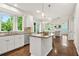 Open kitchen with stainless steel appliances, a central island, natural lighting, and wood floors at 11260 Havenwood Dr, Johns Creek, GA 30097