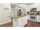 Kitchen with an island, stainless steel appliances, granite countertops, and wood floors at 11260 Havenwood Dr, Johns Creek, GA 30097
