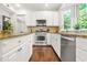 Modern kitchen features stainless steel appliances, tile backsplash, and wood floors at 11260 Havenwood Dr, Johns Creek, GA 30097
