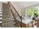 Charming living room showcasing hardwood floors, staircase, and sun-filled windows with green views at 11260 Havenwood Dr, Johns Creek, GA 30097