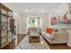 Cozy living room showcasing hardwood floors, natural light and a staircase at 11260 Havenwood Dr, Johns Creek, GA 30097