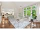 Bright living room featuring large windows, hardwood floors, and a comfortable sectional sofa at 11260 Havenwood Dr, Johns Creek, GA 30097