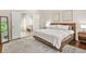Well-lit bedroom with hardwood floors, a king-size bed and a view into the ensuite bathroom at 11260 Havenwood Dr, Johns Creek, GA 30097