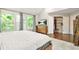Bright main bedroom boasts large windows, a walk-in closet, and a wooden dresser with modern decor at 11260 Havenwood Dr, Johns Creek, GA 30097
