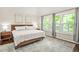 Serene main bedroom featuring a king-sized bed, hardwood floors and large windows at 11260 Havenwood Dr, Johns Creek, GA 30097