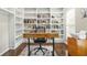Office space with hardwood floors, built-in bookshelves filled with books, and a printer at 11260 Havenwood Dr, Johns Creek, GA 30097