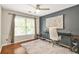 Bright office space with hardwood floors, modern desk and chair, and a large window with natural light at 11260 Havenwood Dr, Johns Creek, GA 30097