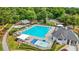 An overhead shot of the community pool with lounge chairs and picnic tables in a lush setting at 11260 Havenwood Dr, Johns Creek, GA 30097