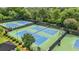 Overhead view of the community tennis courts with lighting, benches, and perimeter fencing at 11260 Havenwood Dr, Johns Creek, GA 30097