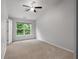 Neutral bedroom features a ceiling fan, natural light, and plush carpeting at 1529 Liberty Nw Pkwy, Atlanta, GA 30318