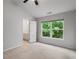 Bedroom with a ceiling fan, view of the outside, access to a bathroom, and plush carpeting at 1529 Liberty Nw Pkwy, Atlanta, GA 30318