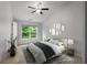 Bright bedroom with a ceiling fan, natural light, and a stylish bed with decorative wall art at 1529 Liberty Nw Pkwy, Atlanta, GA 30318