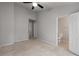 Large bedroom with a ceiling fan, access to a bathroom, plush carpeting, and neutral walls at 1529 Liberty Nw Pkwy, Atlanta, GA 30318