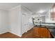 Kitchen area with access to a view of the staircase and featuring granite countertops and hardwood floors at 1529 Liberty Nw Pkwy, Atlanta, GA 30318