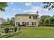 Large backyard features a deck, fire pit, mature trees, and ample space for outdoor activities at 2904 Masonwood Nw Dr, Kennesaw, GA 30152