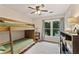 Comfortable bedroom with bunkbeds, a ceiling fan, a view to the outdoors, and built-in storage at 2904 Masonwood Nw Dr, Kennesaw, GA 30152