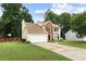 Beautiful two-story home with a well-maintained lawn and two-car garage, surrounded by mature trees at 2904 Masonwood Nw Dr, Kennesaw, GA 30152
