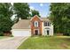 Charming two-story home featuring a well-manicured lawn, brick accents and a two-car garage at 2904 Masonwood Nw Dr, Kennesaw, GA 30152